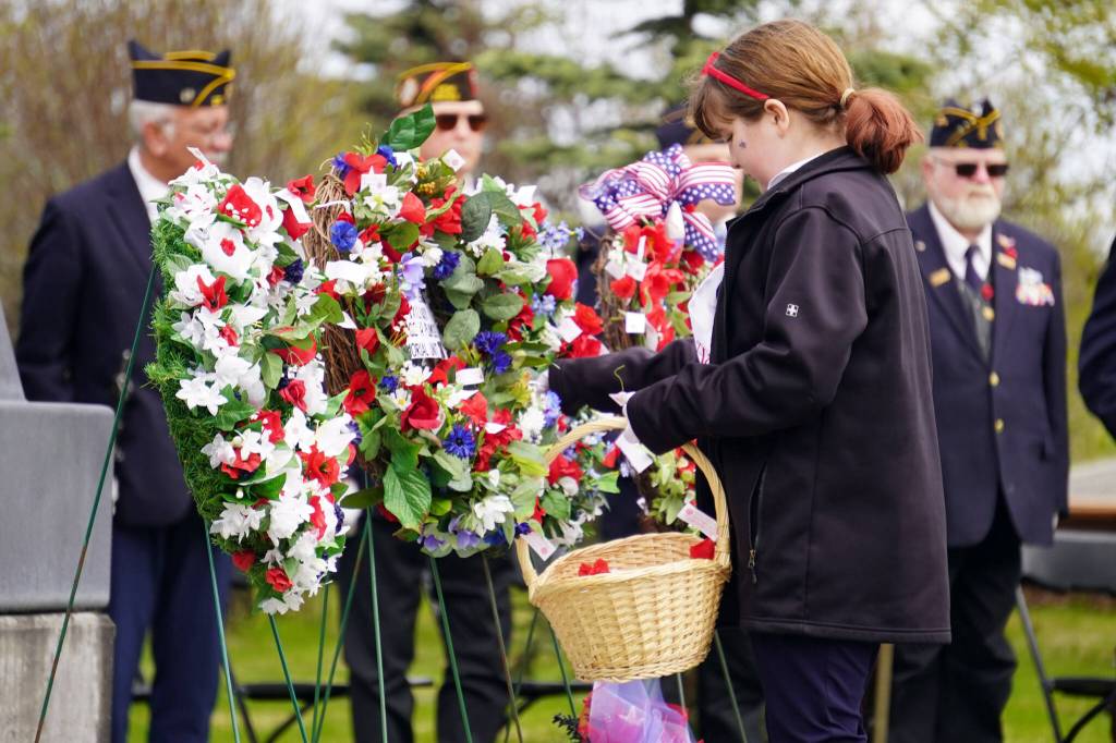 Poppies are affixed to wreaths during a Memorial Day ceremony at Leif Hanson Memorial Park in Kenai, Alaska, on Monday, May 27, 2024. (Jake Dye/Peninsula Clarion)