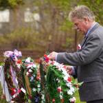 Poppies are affixed to wreaths during a Memorial Day ceremony at Leif Hanson Memorial Park in Kenai, Alaska, on Monday, May 27, 2024. (Jake Dye/Peninsula Clarion)