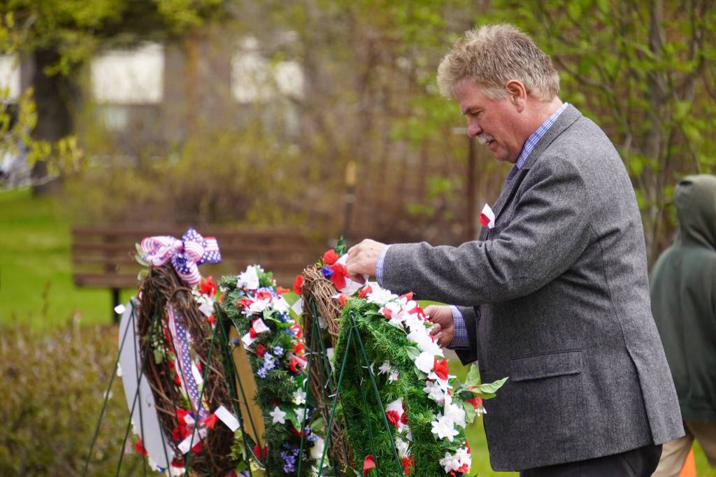 Poppies are affixed to wreaths during a Memorial Day ceremony at Leif Hanson Memorial Park in Kenai, Alaska, on Monday, May 27, 2024. (Jake Dye/Peninsula Clarion)