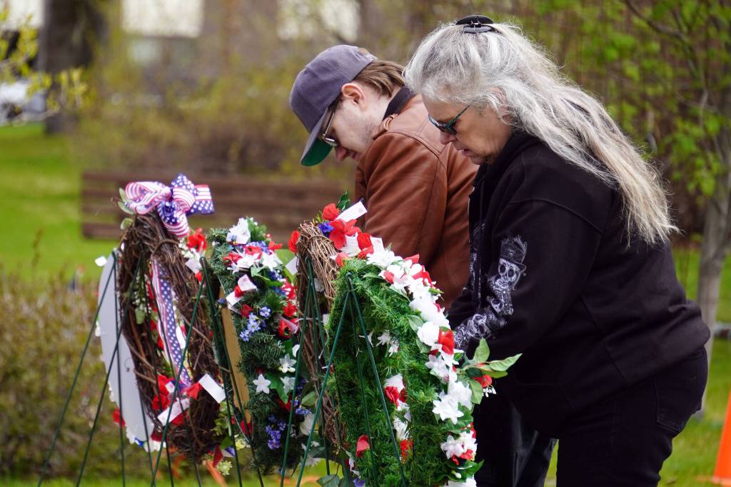 Poppies are affixed to wreaths during a Memorial Day ceremony at Leif Hanson Memorial Park in Kenai, Alaska, on Monday, May 27, 2024. (Jake Dye/Peninsula Clarion)