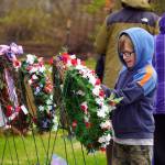 Poppies are affixed to wreaths during a Memorial Day ceremony at Leif Hanson Memorial Park in Kenai, Alaska, on Monday, May 27, 2024. (Jake Dye/Peninsula Clarion)