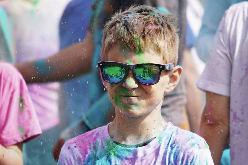Participants are covered with colored powder during a color run held as part of during the Levitt AMP Soldotna Music Series on Wednesday, June 7, 2023, at the Kenai National Wildlife Refuge Visitors Center in Soldotna (Jake Dye/Peninsula Clarion)
