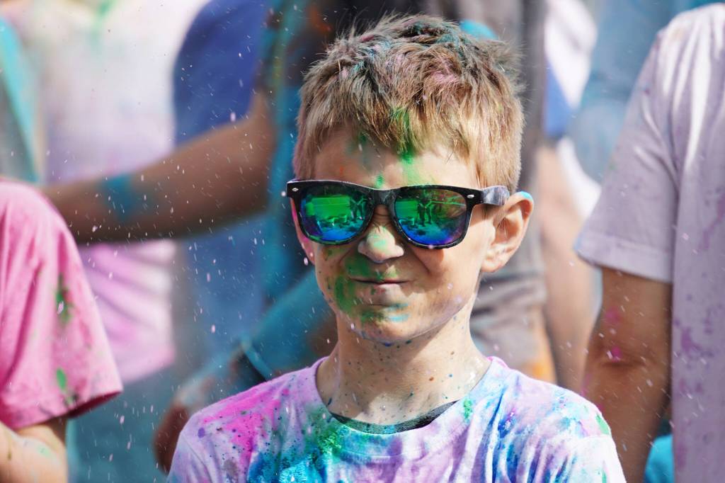 Participants are covered with colored powder during a color run held as part of during the Levitt AMP Soldotna Music Series on Wednesday, June 7, 2023, at the Kenai National Wildlife Refuge Visitors Center in Soldotna, Alaska. (Jake Dye/Peninsula Clarion)