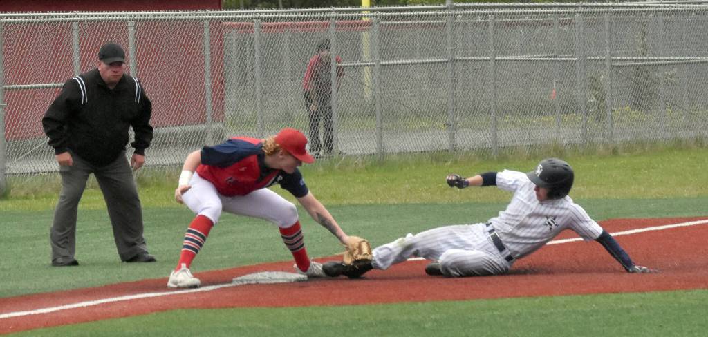 Soldotnas Levi Mickelson slides in safely for a triple in front of North Poles Olan Tucker in the Division II state championship game Saturday, June 1, 2024, at Wasilla High School in Wasilla, Alaska. Mickelson was called safe when the ball popped out of Tuckers glove. (Photo by Jeff Helminiak/Peninsula Clarion)