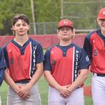 North Pole senior Simeon Langer (10) sports the results of crashing into the left-field fence to catch a fly ball in the Division II state tournament final against Soldotna on Saturday, June 1, 2024, at Wasilla High School in Wasilla, Alaska. Also pictured are fellow seniors Kenai Borgen, Ryan Martinez and Olan Tucker. (Photo by Jeff Helminiak/Peninsula Clarion)