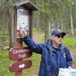 A guide from the Kenai National Wildlife Refuge leads visitors on a hike of Centennial Trail near Soldotna on Saturday, June 1, 2024. (Jake Dye/Peninsula Clarion)