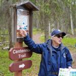 A guide from the Kenai National Wildlife Refuge leads visitors on a hike of Centennial Trail near Soldotna, Alaska, on Saturday, June 1, 2024. (Jake Dye/Peninsula Clarion)