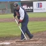 American Legion Post 20 Twins assistant coach Ken Gibson works the diamond between innings of a game against Eagle River on Wednesday, June 5, 2024, at Coral Seymour Memorial Park in Kenai, Alaska. (Photo by Jeff Helminiak/Peninsula Clarion)