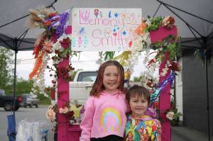 Rylee Smith operates her lemonade stand, Lemony Smith, outside of Orange Poppy in Soldotna during Lemonade Day on Saturday. (Jake Dye/Peninsula Clarion)