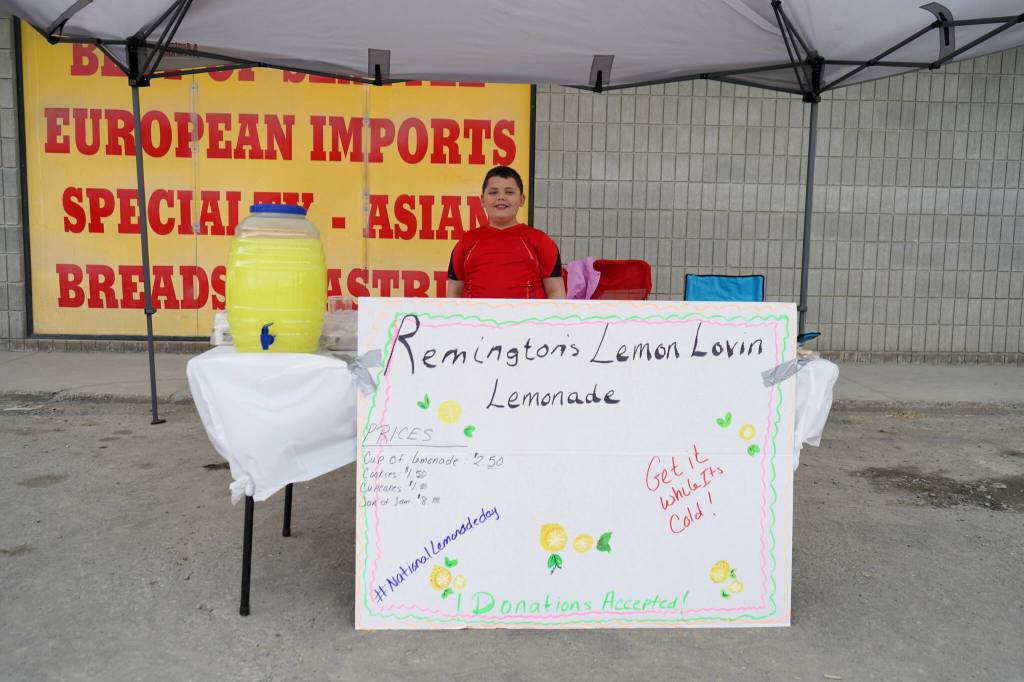 Remington operates his lemonade stand, Remingtons Lemon Lovin Lemonade, outside of Save U More near Soldotna, Alaska, during Lemonade Day on Saturday, June 8, 2024. (Jake Dye/Peninsula Clarion)