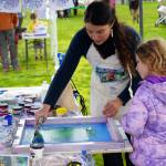 Children participate in a painting activity led by Cook Inletkeeper during the Kenai River Fair at Soldotna Creek Park in Soldotna, Alaska, on Saturday, June 7, 2024. (Jake Dye/Peninsula Clarion)
