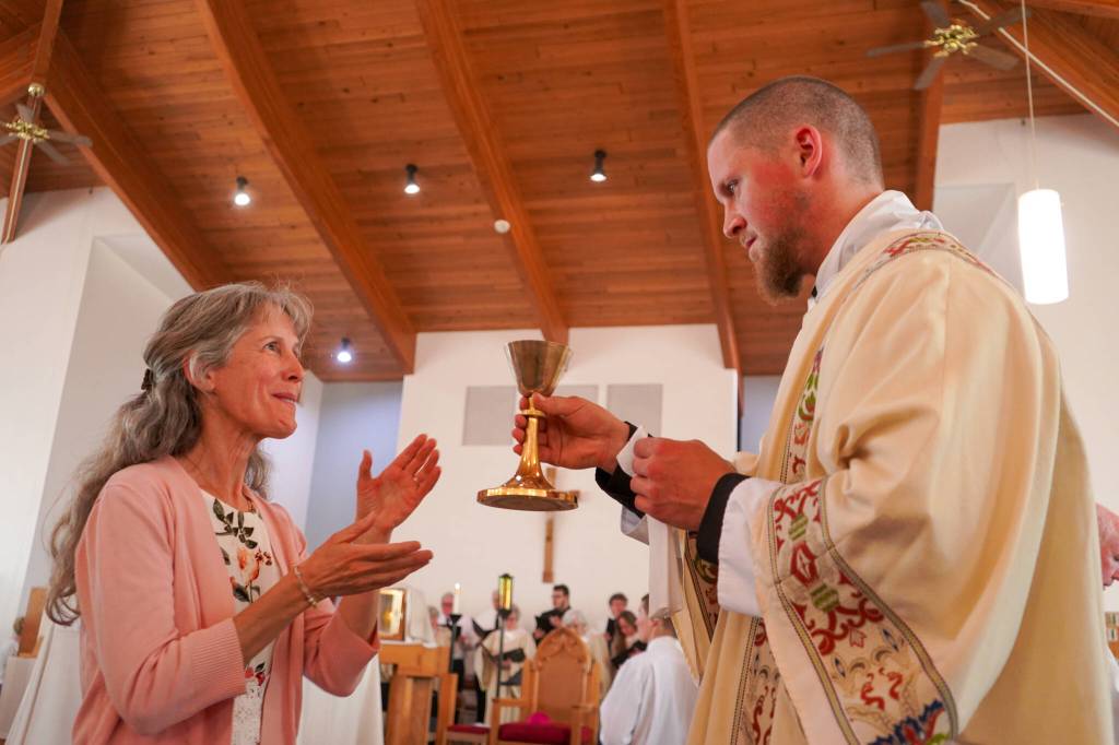 Deacon Edward Burke administers communion after being ordained a transitional deacon at Our Lady of the Angels Catholic Church in Kenai, Alaska, on Saturday, June 8, 2024. (Photo provided by Our Lady of the Angels Catholic Church)