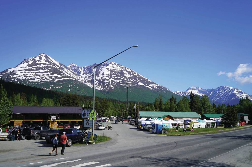 People converge towards the 45th Annual Moose Pass Summer Solstice Festival in Moose Pass on Saturday, June 15. (Jake Dye/Peninsula Clarion)