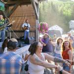 Attendees dance and smile while the Tyson James Band performs during the 45th Annual Moose Pass Summer Solstice Festival on Saturday, June 15. (Jake Dye/Peninsula Clarion)