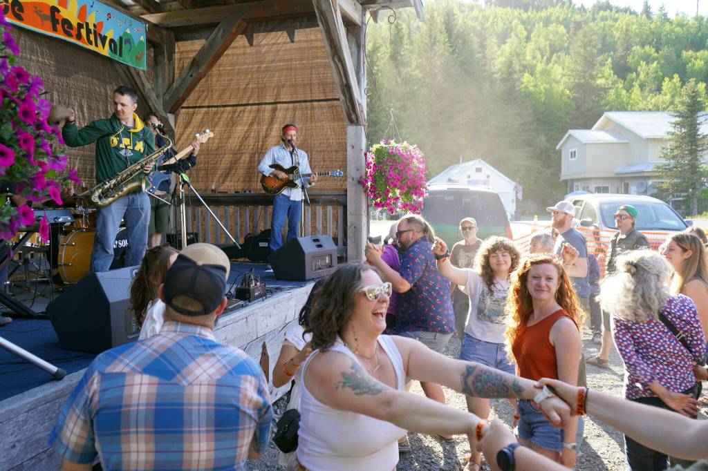 Attendees dance and smile while the Tyson James Band performs during the 45th Annual Moose Pass Summer Solstice Festival in Moose Pass, Alaska, on Saturday, June 15, 2024. (Jake Dye/Peninsula Clarion)