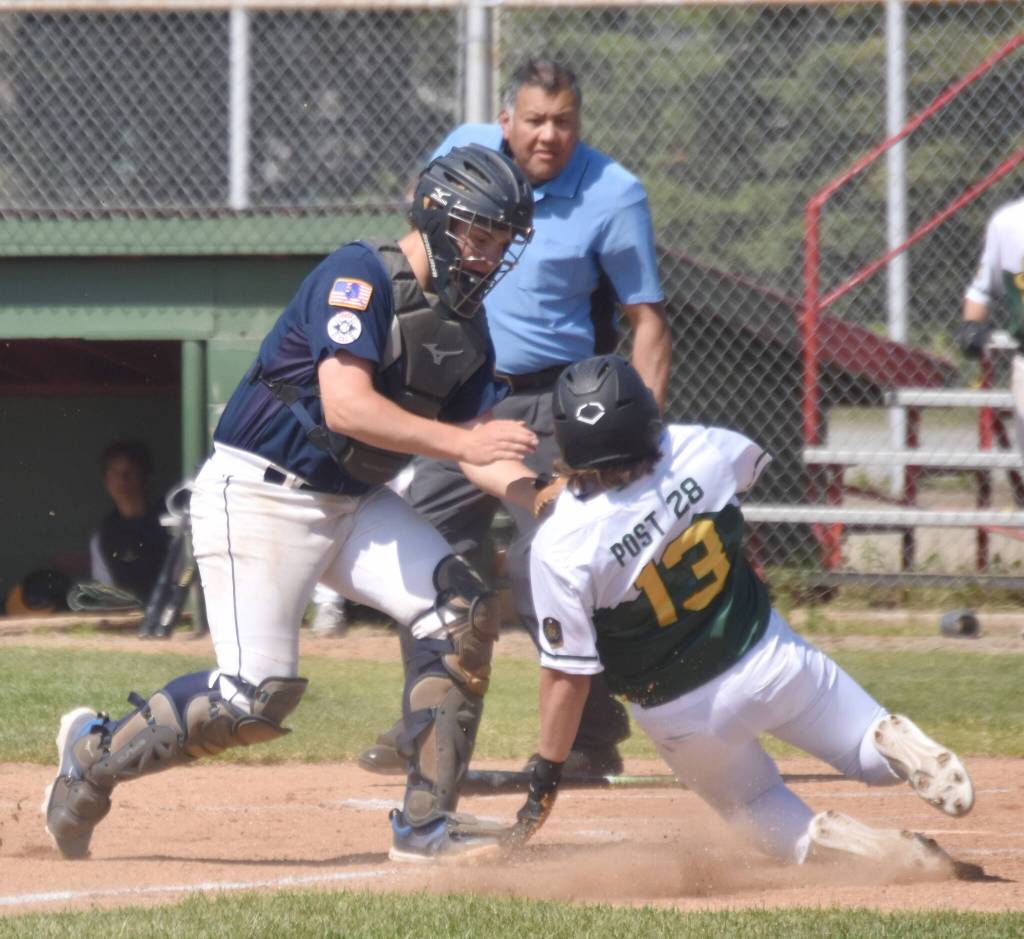 Post 20 Twins catcher Jayden Stuyvesant tags out Trey Maltby at the plate Sunday, June 23, 2024, at Coral Seymour Memorial Park in Kenai, Alaska. (Photo by Jeff Helminiak/Peninsula Clarion)