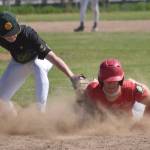 Napoleon (Ohio) River Bandits player Kadyn Radzik dives back into first safely in front of Service first baseman Owen Hickman in the final of the Lance Coz Wood Bat Tournament on Monday, June 24, 2024, at Coral Seymour Memorial Park in Kenai, Alaska. (Photo by Jeff Helminiak/Peninsula Clarion)