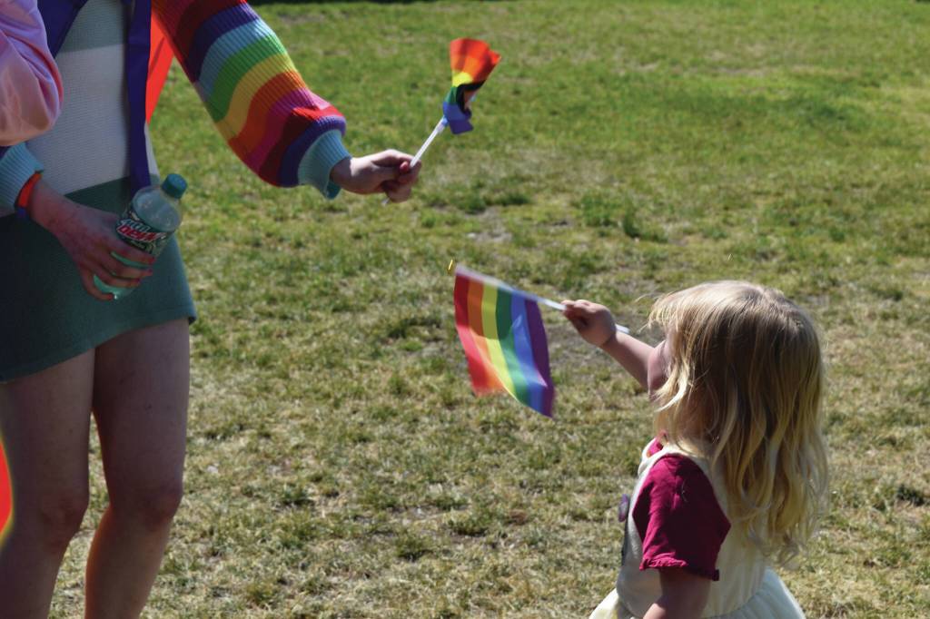A young girl waves a Pride flag at the Saturday, June 22<ins>, 2024,</ins> Pride in the Park celebration in Soldotna<ins>, Alaska</ins>. (Photo by Erin Thompson/Peninsula Clarion)