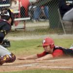 Cole Dawson of the Peninsula Oilers slides into home safely in front of Anchorage Bucs catcher Brody Briggs on Thursday, June 27, 2024, at Coral Seymour Memorial Park in Kenai, Alaska. (Photo by Jeff Helminiak/Peninsula Clarion)