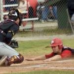 Cole Dawson of the Peninsula Oilers slides into home safely in front of Anchorage Bucs catcher Brody Briggs on Thursday, June 27, 2024, at Coral Seymour Memorial Park in Kenai. (Photo by Jeff Helminiak/Peninsula Clarion)