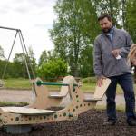 Kenai Parks and Recreation Director Tyler Best shows off a new inclusive seesaw at Kenai Municipal Park in Kenai, Alaska, on Thursday, June 27, 2024. (Jake Dye/Peninsula Clarion)