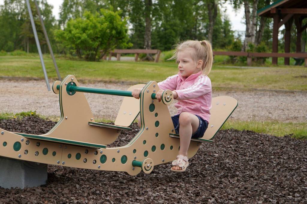 A child tries out the new inclusive seesaw at Kenai Municipal Park in Kenai, Alaska, on Thursday, June 27, 2024. (Jake Dye/Peninsula Clarion)