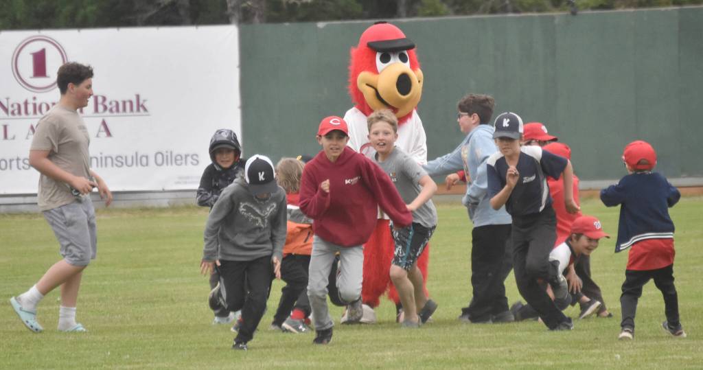 Kids play tag the mascot with Scoop on Saturday, June 29, 2024, at Coral Seymour Memorial Park in Kenai, Alaska. (Photo by Jeff Helminiak/Peninsula Clarion)