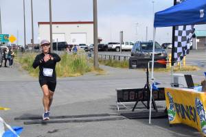 Ben London, from Seattle, Washington, crosses the finish line at Lands End Resort, completing the Homer Spit Run Cosmic Hamlet Half Marathon on Saturday, June 29, 2024, in Homer, Alaska.