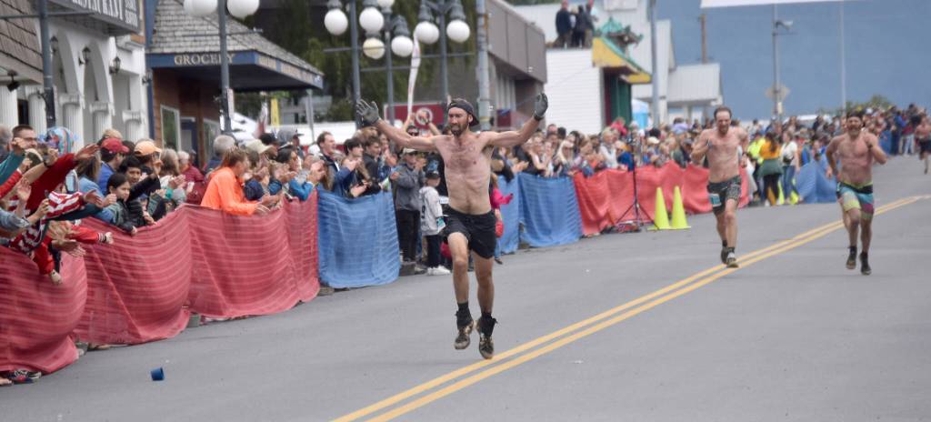 James Carlberg, Pyper Dixon and Erik Johnson race for top spots in the mens race at the Mount Marathon Race on Thursday, July 4, 2024, in Seward, Alaska. Carlberg was 16th, Dixon was 17th and Johnson was 18th. (Photo by Jeff Helminiak/Peninsula Clarion)