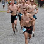 David Norris of Steamboat Springs, Colorado, leads a group of runners to the mountain on the way to victory and setting a new record in the mens race at the Mount Marathon Race on Thursday, July 4, 2024, in Seward, Alaska. (Photo by Jeff Helminiak/Peninsula Clarion)