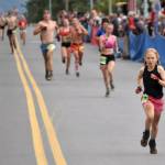 Palmers Wren Spangler beats a pack of runners to the line to finish second in the girls race at the Mount Marathon Race on Thursday, July 4, 2024, in Seward, Alaska. (Photo by Jeff Helminiak/Peninsula Clarion)