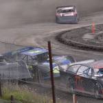 Alex Schwochert (back left) battles Jesse Wilson (34) and Damien LeMountain (77) in Late Model Heat 1 on Sunday, July 7, 2024, in the Skylar Thomas Lyon Memorial at Twin City Raceway in Kenai, Alaska. Schwochert won, while Wilson was third and LeMountain was fifth. (Photo by Jeff Helminiak/Peninsula Clarion)