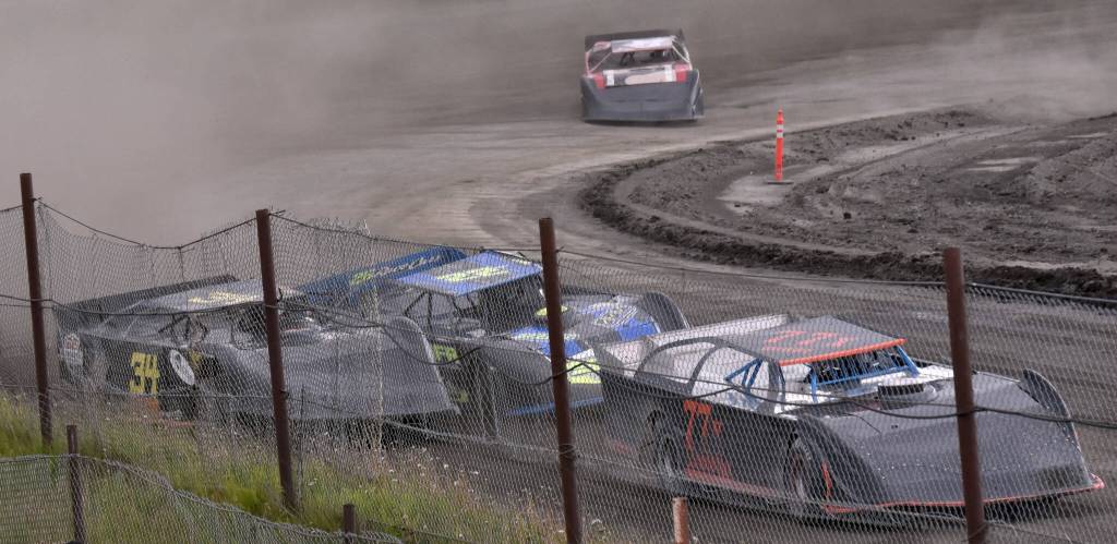 Alex Schwochert (back left) battles Jesse Wilson (34) and Damien LeMountain (77) in Late Model Heat 1 on Sunday, July 7, 2024, in the Skylar Thomas Lyon Memorial at Twin City Raceway in Kenai, Alaska. Schwochert won, while Wilson was third and LeMountain was fifth. (Photo by Jeff Helminiak/Peninsula Clarion)