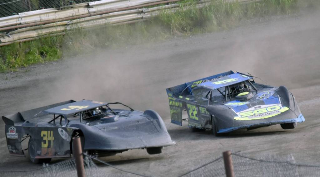 Jesse Wilson and Alex Schwochert both have front tires off the ground as they swing around Turn 4 in Late Model Heat 2 on Sunday, July 7, 2024, in the Skylar Thomas Lyon Memorial at Twin City Raceway in Kenai, Alaska. Wilson was first, while Schwochert was second. (Photo by Jeff Helminiak/Peninsula Clarion)