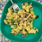 Scrambled eggs with diced zucchini, kielbasa sausage and broccoli florets cooked over a firepit make a hearty and doable outdoors meal. (Photo by Tressa Dale/Peninsula Clarion)