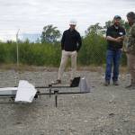 Furie Operations Superintendent Ben Christianson, Furie Operations Engineer Hunter Van Wyhe and HEX President and CEO John Hendrix celebrate a successful test of a drone that flies beyond visual line of sight at Furies central processing facility in Nikiski, Alaska, on Wednesday, July 10, 2024. (Jake Dye/Peninsula Clarion)