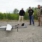Furie Operations Superintendent Ben Christianson, Furie Operations Engineer Hunter Van Wyhe and HEX President and CEO John Hendrix celebrate a successful test of a drone that flies beyond visual line of sight at Furies central processing facility in Nikiski, Alaska, on Wednesday, July 10, 2024. (Jake Dye/Peninsula Clarion)