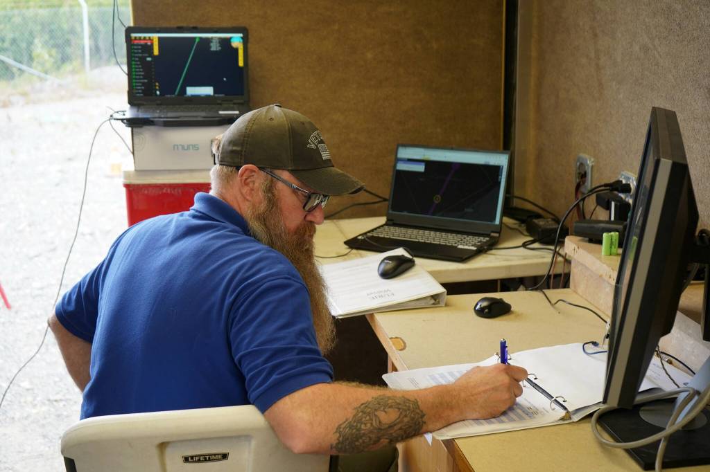 Jason Williams operates a test of a drone that flies beyond visual line of sight at Furies central processing facility in Nikiski, Alaska, on Wednesday, July 10, 2024. Williams was one of two pilots who ran the drone at either end of its route, passing off control in the middle, but the drone largely followed its flight path via autopilot. (Jake Dye/Peninsula Clarion)