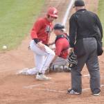 Colin Robson of the Peninsula Oilers slides in safe in front of Chugiak-Eagle River Chinooks catcher Dustin Isanogle during the second game of a doubleheader Sunday, July 14, 2024, at Coral Seymour Memorial Park in Kenai, Alaska. (Photo by Jeff Helminiak/Peninsula Clarion)