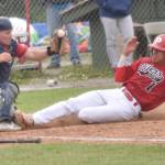 Chugiak-Eagle River Chinooks catcher Dustin Isanogle tags out Petey Soto of the Peninsula Oilers at home during the second game of a doubleheader Sunday, July 14, 2024, at Coral Seymour Memorial Park in Kenai, Alaska. (Photo by Jeff Helminiak/Peninsula Clarion)