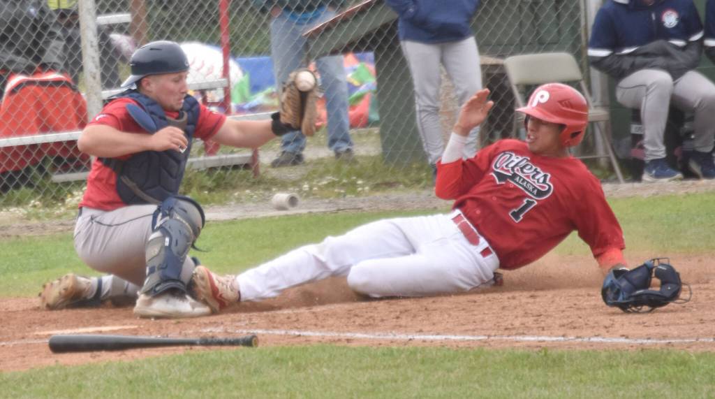 Chugiak-Eagle River Chinooks catcher Dustin Isanogle tags out Petey Soto of the Peninsula Oilers at home during the second game of a doubleheader Sunday, July 14, 2024, at Coral Seymour Memorial Park in Kenai, Alaska. (Photo by Jeff Helminiak/Peninsula Clarion)