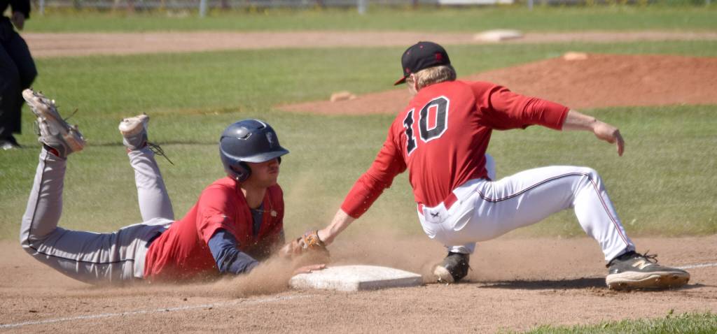 Louis Zulaica of the Chugiak-Eagle River Chinooks steals third under the tag of Cole Dawson of the Oilers during the first game of a doubleheader Sunday, July 14, 2024, at Coral Seymour Memorial Park in Kenai, Alaska. (Photo by Jeff Helminiak/Peninsula Clarion)