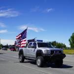 A parade of cars and trucks flying flags in support of former President Donald Trump proceed down the Kenai Spur Highway in Kenai, Alaska, on Sunday, July 14, 2024. (Jake Dye/Peninsula Clarion)