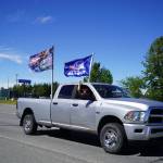 A parade of cars and trucks flying flags in support of former President Donald Trump proceed down the Kenai Spur Highway in Kenai, Alaska, on Sunday, July 14, 2024. (Jake Dye/Peninsula Clarion)