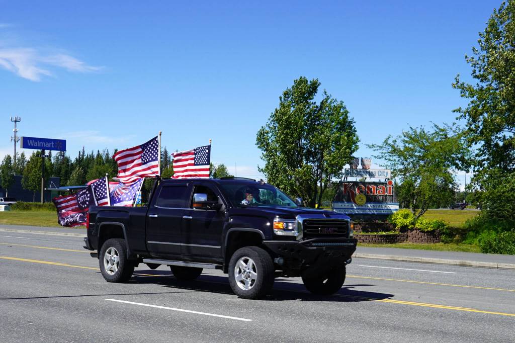 A parade of cars and trucks flying flags in support of former President Donald Trump proceed down the Kenai Spur Highway in Kenai, Alaska, on Sunday, July 14, 2024. (Jake Dye/Peninsula Clarion)