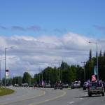 A parade of cars and trucks flying flags in support of former President Donald Trump proceed down the Kenai Spur Highway in Kenai, Alaska, on Sunday, July 14, 2024. (Jake Dye/Peninsula Clarion)
