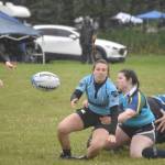 Beth Pokorny of Scylla Rugby gets rid of the ball while being tackled by Rahel Dean-Pelikan of the Kenai River SheWolves at the Kenai Dipnet Fest Rugby 10s Tournament on Saturday, July 13, 2024, in Kenai, Alaska. (Photo by Jeff Helminiak/Peninsula Clarion)