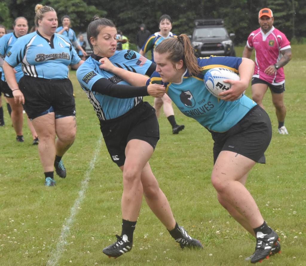 Beth Pokorny of Scylla Rugby tries to slow down Jay Port of the Kenai River SheWolves at the Kenai Dipnet Fest Rugby 10s Tournament on Saturday, July 13, 2024, in Kenai, Alaska. (Photo by Jeff Helminiak/Peninsula Clarion)