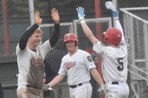 Post 20 Twins catcher Jayden Stuyvesant congratulates Malakai Olson on the game-winning hit Saturday, July 6, 2024, at Coral Seymour Memorial Park in Kenai, Alaska. (Photo by Jeff Helminiak/Peninsula Clarion)
