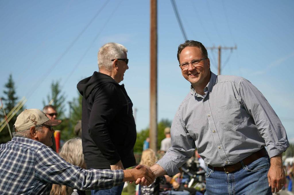 Rep. Ben Carpenter, R-Nikiski, shakes hands as he walks with the 67th Annual Soldotna Progress Days Parade on Marydale Avenue in Soldotna, Alaska, on Saturday, July 27, 2024. (Jake Dye/Peninsula Clarion)